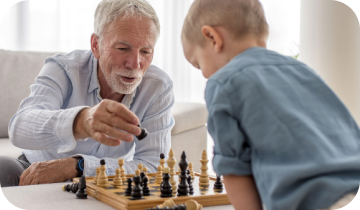 Grandfather playing chess with his grandson